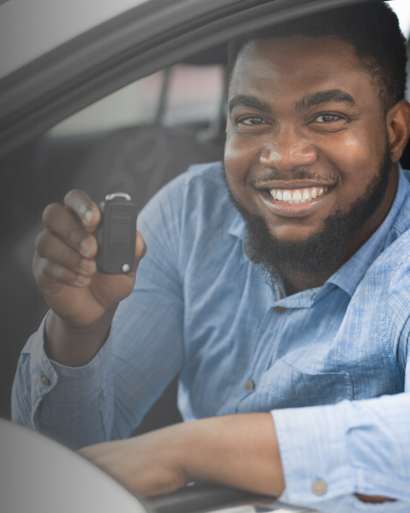 Customer holding car keys inside their rental car