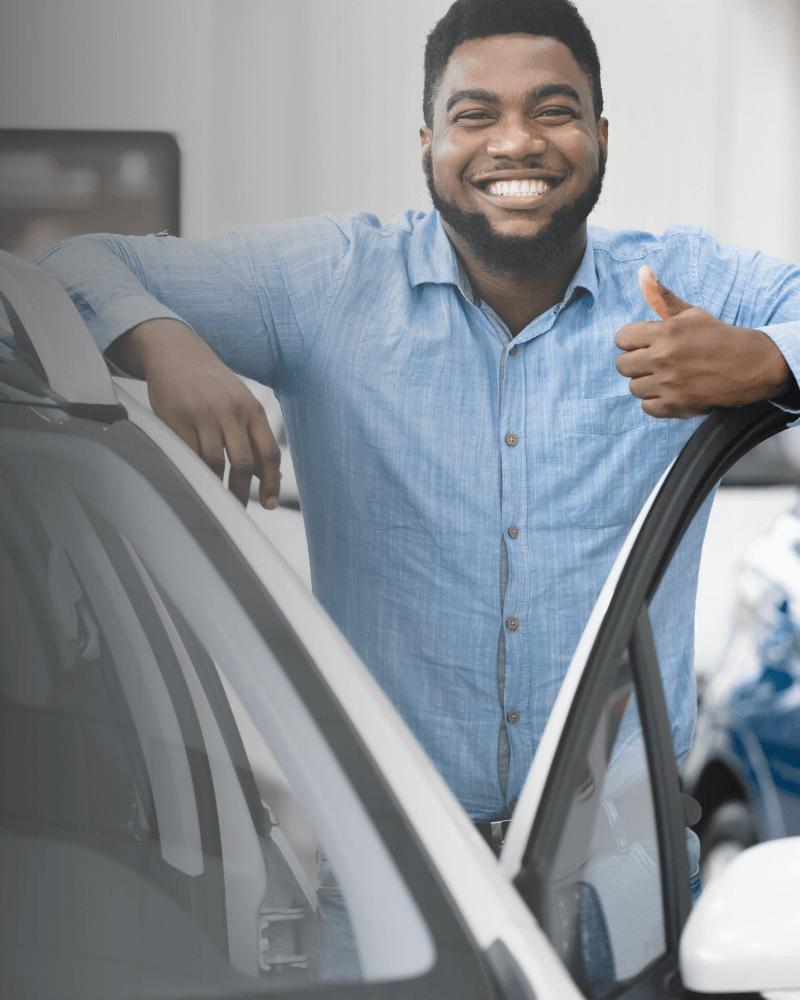 Customer giving a thumbs-up next to their rental car